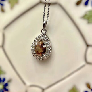 Brown salt and pepper diamond necklace hanging on a wall.