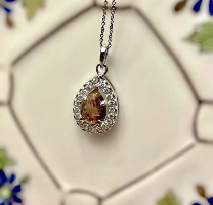 Brown salt and pepper diamond necklace hanging on a wall.