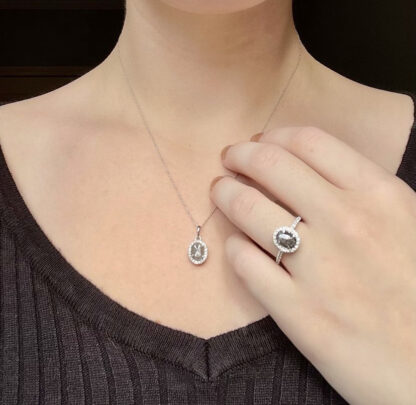 White salt and pepper necklace on a person with salt and pepper ring.